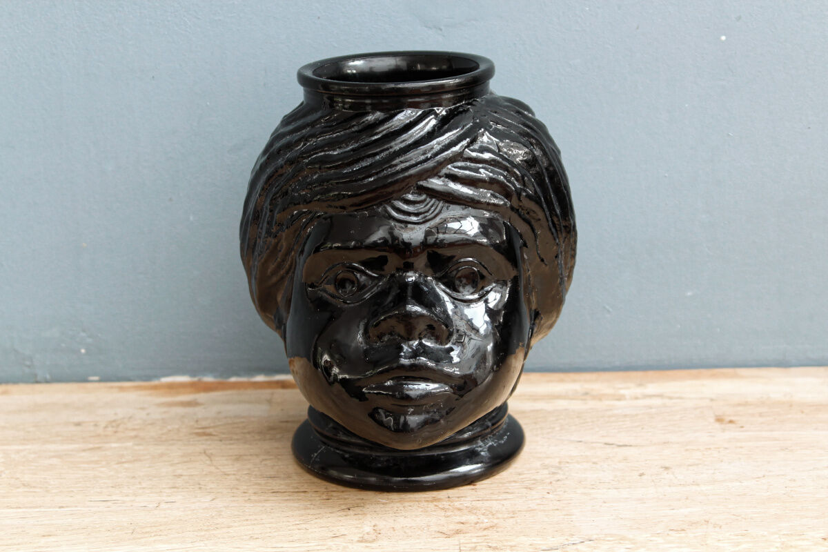 Molded glass vase, nubian's head