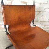 pair of tubular chairs in tawny leather