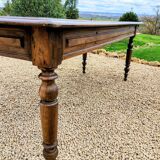 Old French farmhouse table in walnut with turned legs.