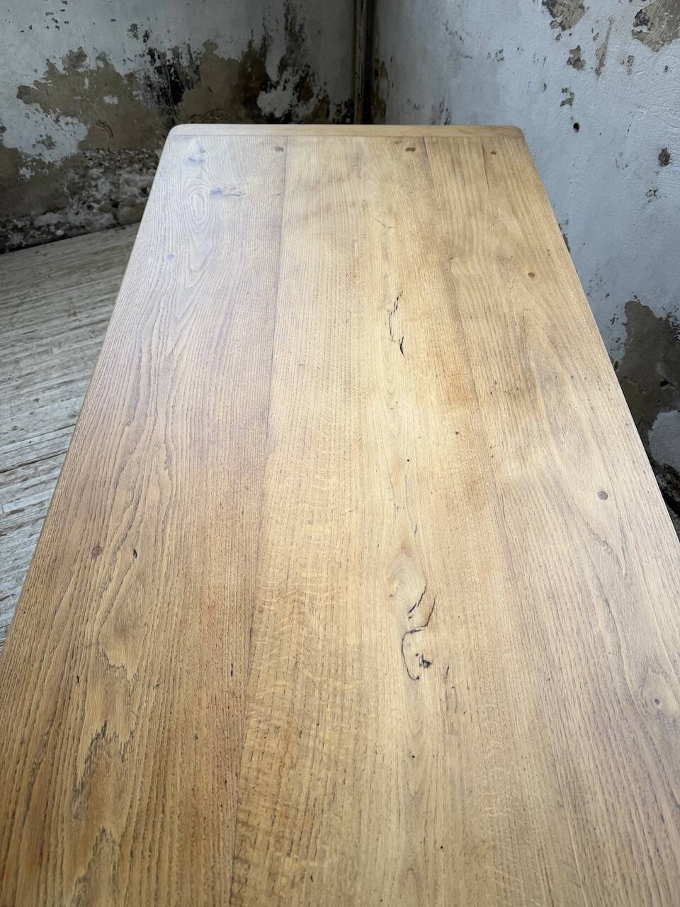 Oak farmhouse table with turned black legs.