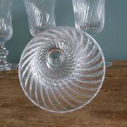 Ancient footed crystal glasses with relief twisted fluted goblets.