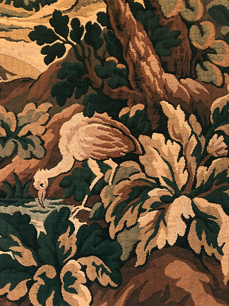 Tapestry decorated with a pink flamingo in a green landscape, woven by hand