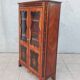 Louis XVI glass-fronted library in rosewood and amaranth veneer.