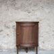 Antique wooden corner cabinet with a curved door.