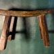 Antique milking stool in rustic curved wood, 19th century