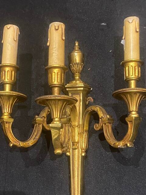 Pair of gilt bronze wall sconces with three lights in the Louis XVI style.
