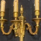 Pair of gilt bronze wall sconces with three lights in the Louis XVI style.