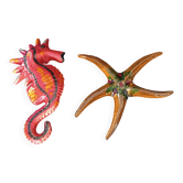 Two vintage ceramic wall pots featuring a seahorse and a starfish.