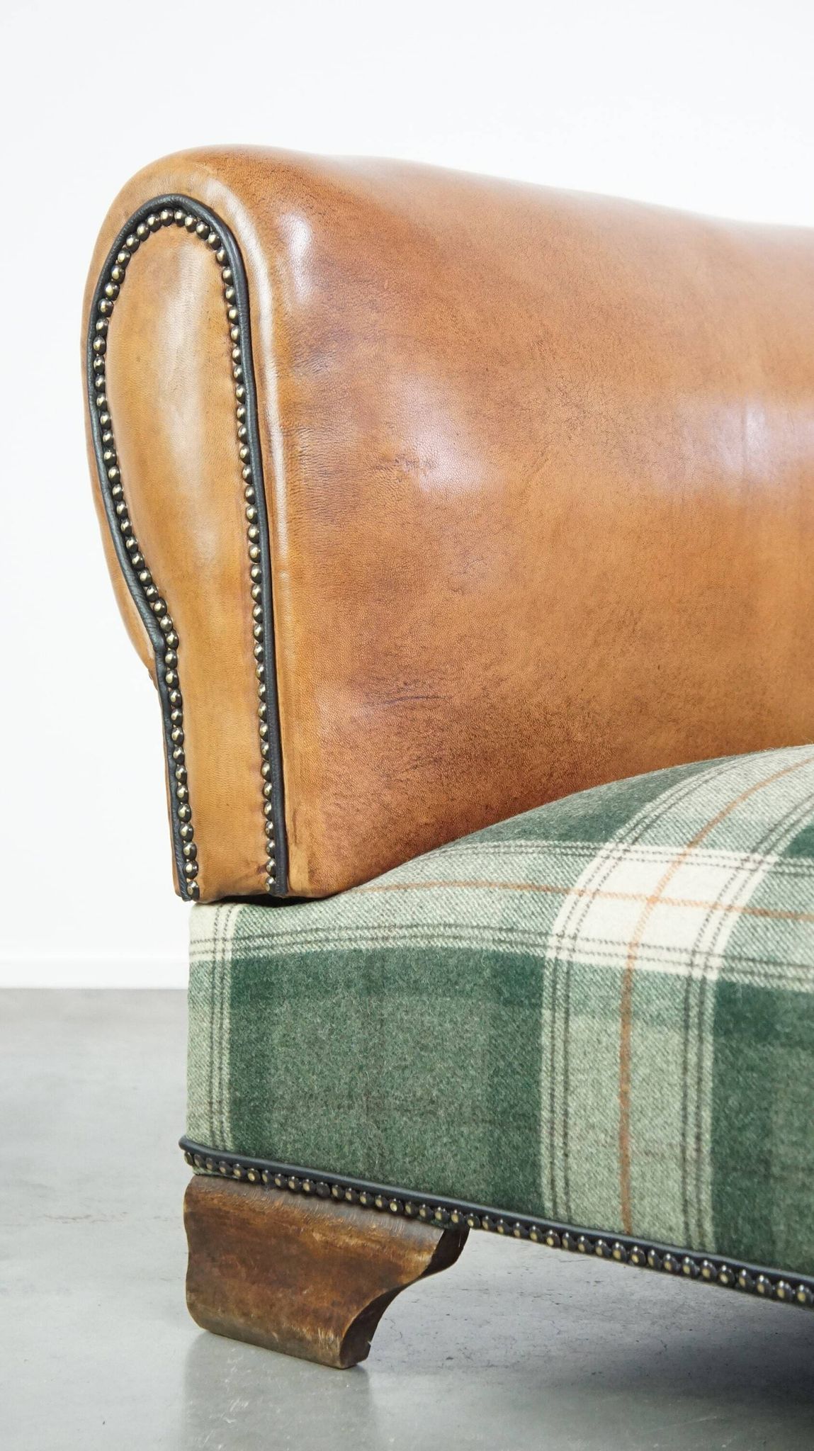 Antique daybed reupholstered with sheepskin and Scottish tartan wool