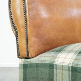 Antique daybed reupholstered with sheepskin and Scottish tartan wool