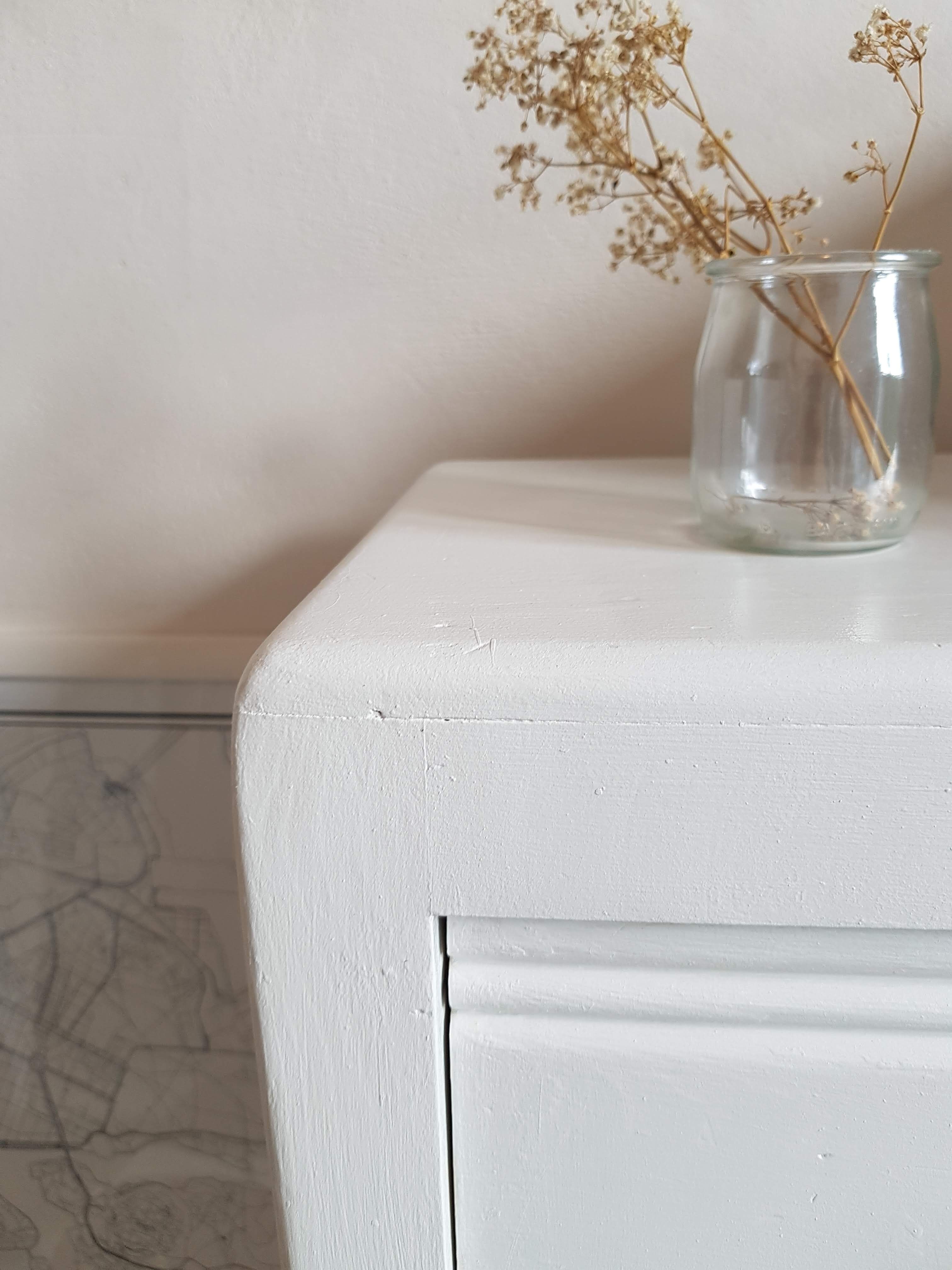 Old white asymmetrical chest of drawers