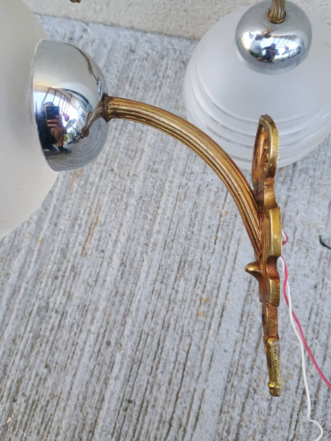 Pair of frosted glass wall lights with brass attachments, circa 1970