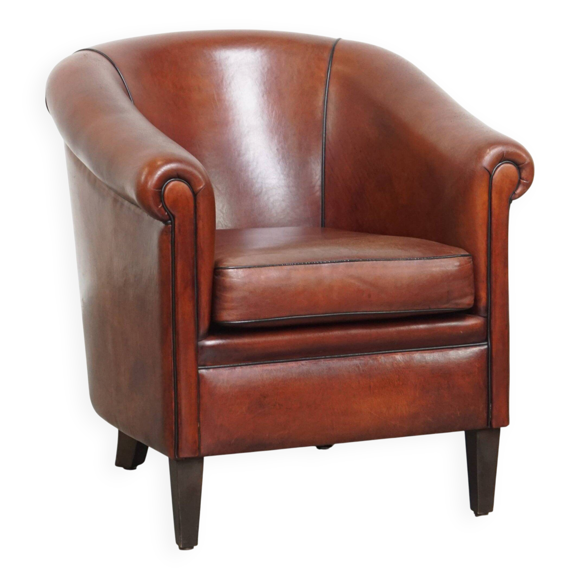 Sheepskin club armchair in a warm deep colour finished with black piping