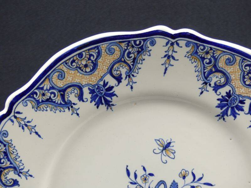 Old earthenware dish with a floral basket decoration.