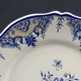 Old earthenware dish with a floral basket decoration.