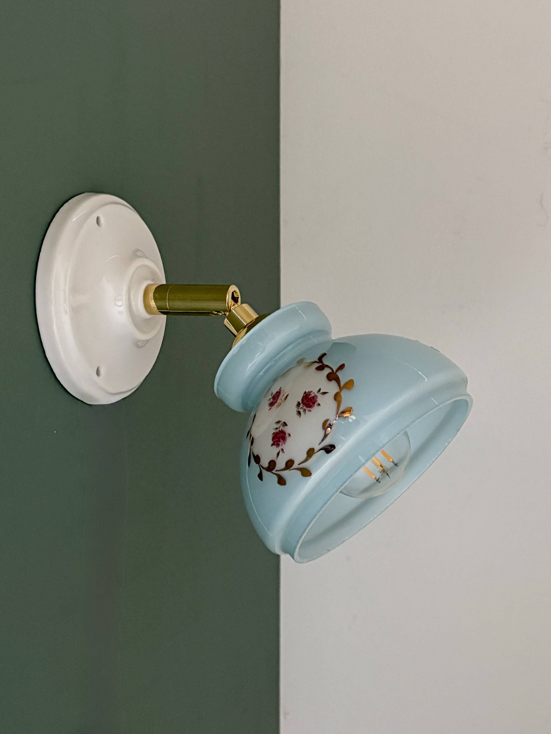 Vintage wall sconce with blue opaline glass shade and floral decorations