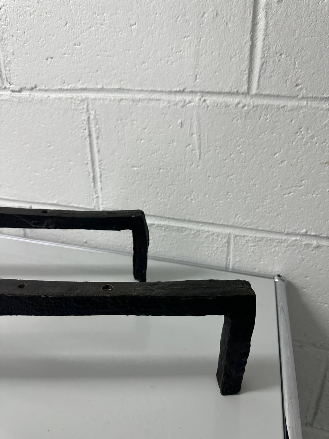 Pair of designer cast iron andirons