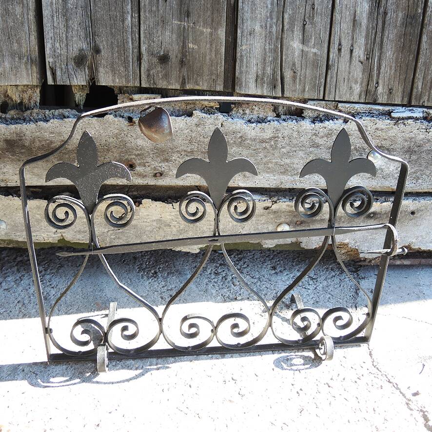 Old wrought iron fleur-de-lis fire screen