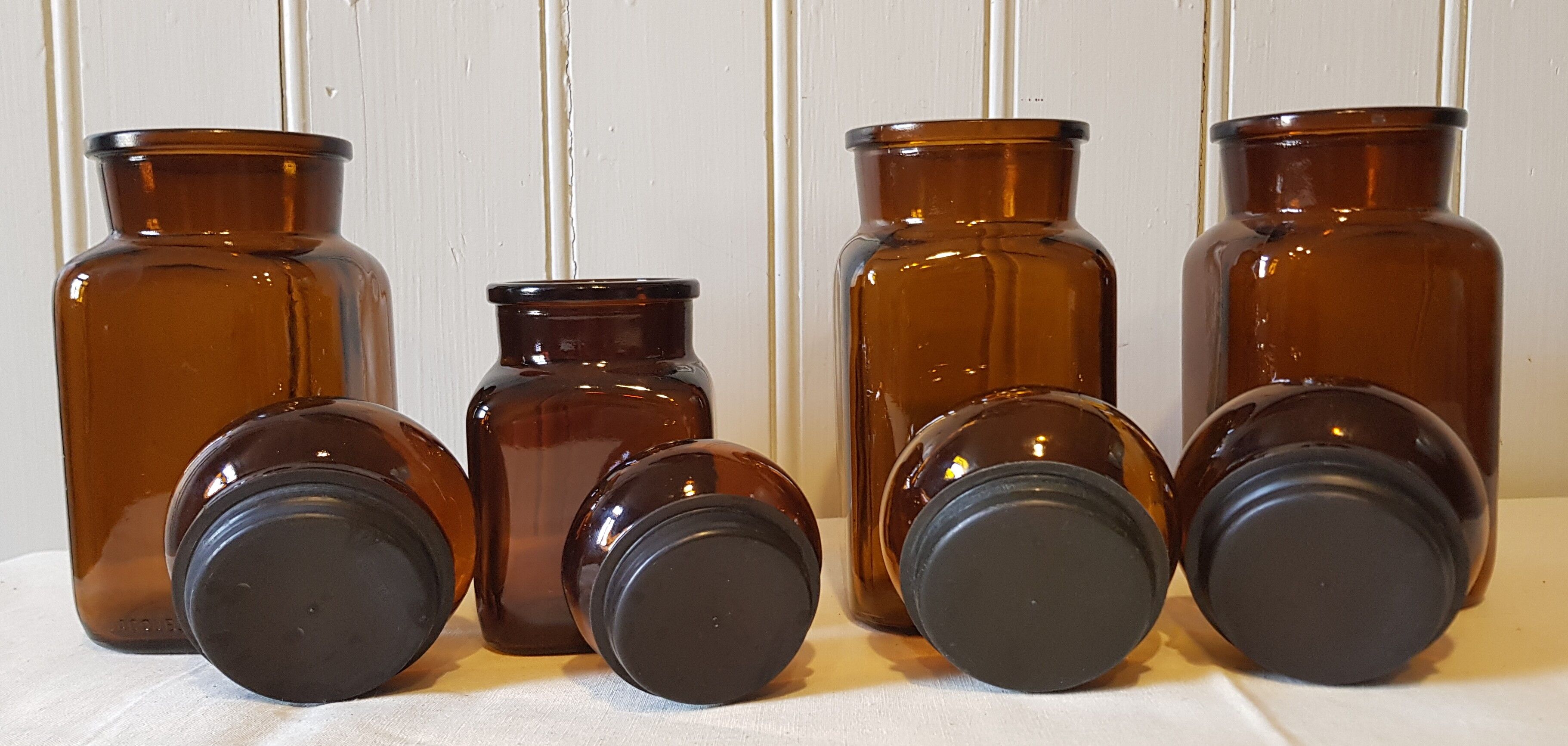 Series of 4  amber glass jars 70