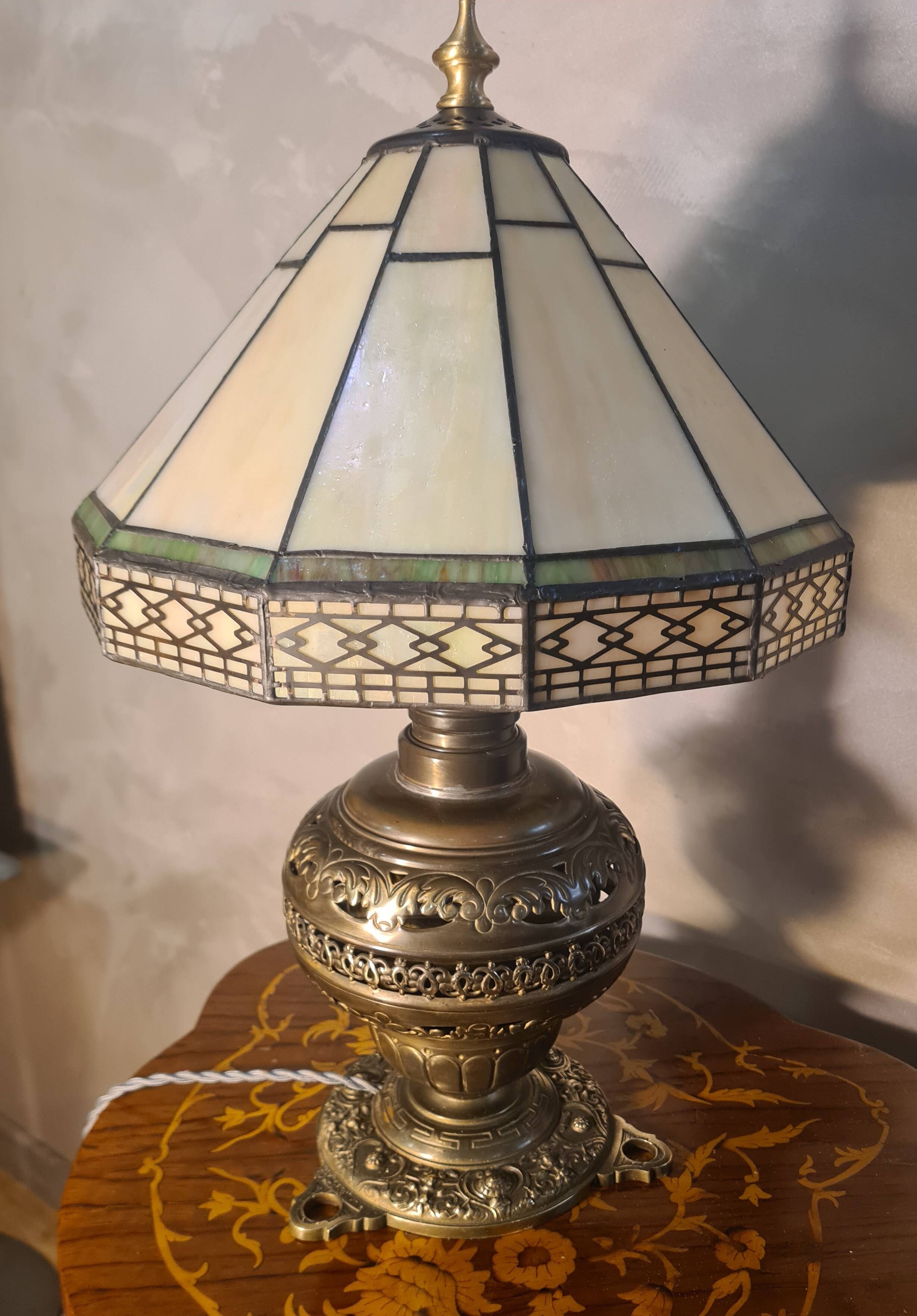 brass and bronze lamp with an antique base from 1900 and a glass paste shade