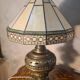 brass and bronze lamp with an antique base from 1900 and a glass paste shade