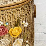 Vintage wicker mannequin with colourful floral decoration.