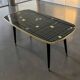 Table basse vintage en formica noir et or