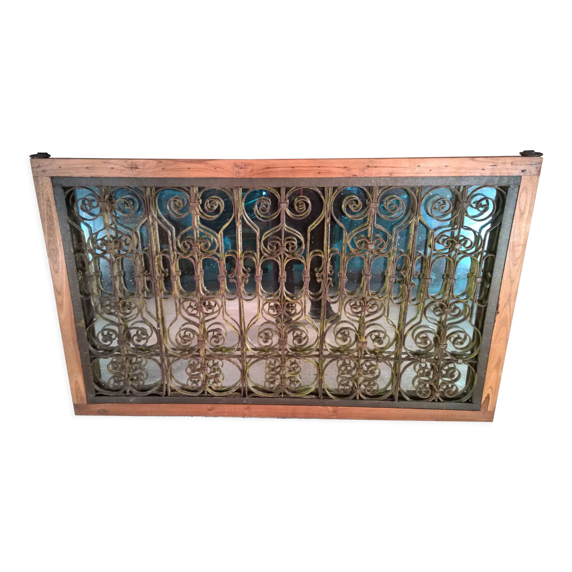 Old wrought iron railing with mirror and teak frame