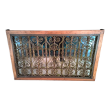 Old wrought iron railing with mirror and teak frame