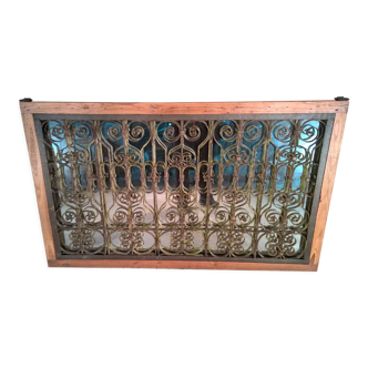 Old wrought iron railing with mirror and teak frame