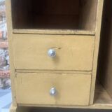 On a piece of furniture with sorting lockers and drawers