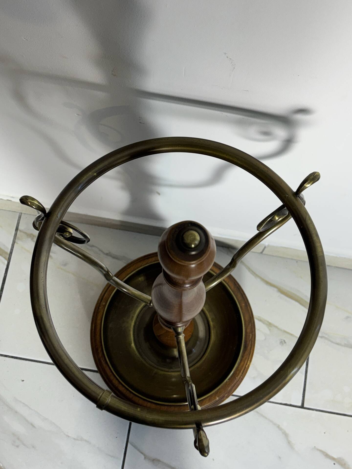 Umbrella stand and English-style wooden and brass canes, 20th century.