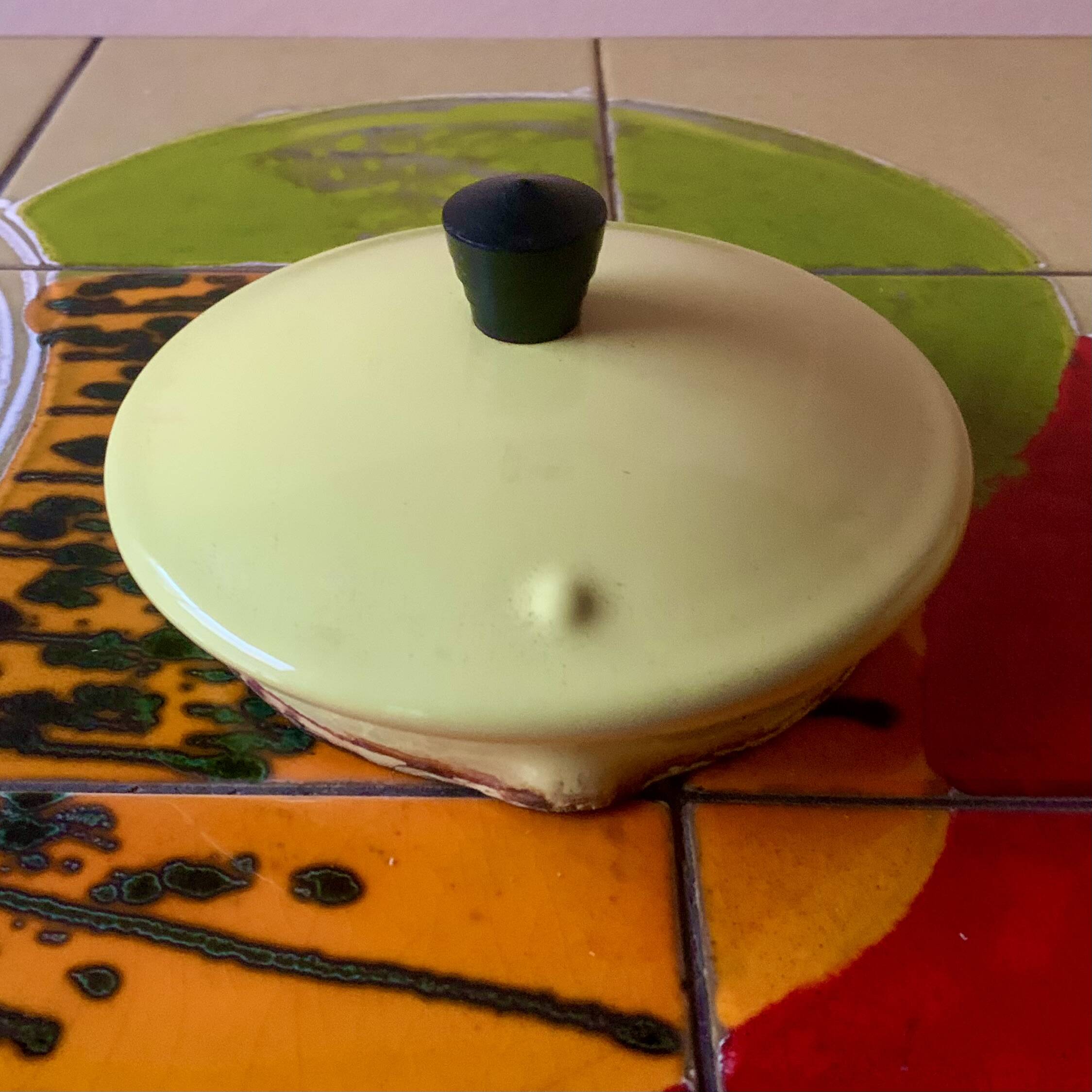 Old kettle in yellow enamelled sheet metal and Bakelite