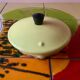 Old kettle in yellow enamelled sheet metal and Bakelite
