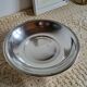 Shallow round metal plate with pearl row decoration.