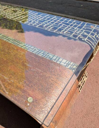 Metal coffee table with a glass top.
