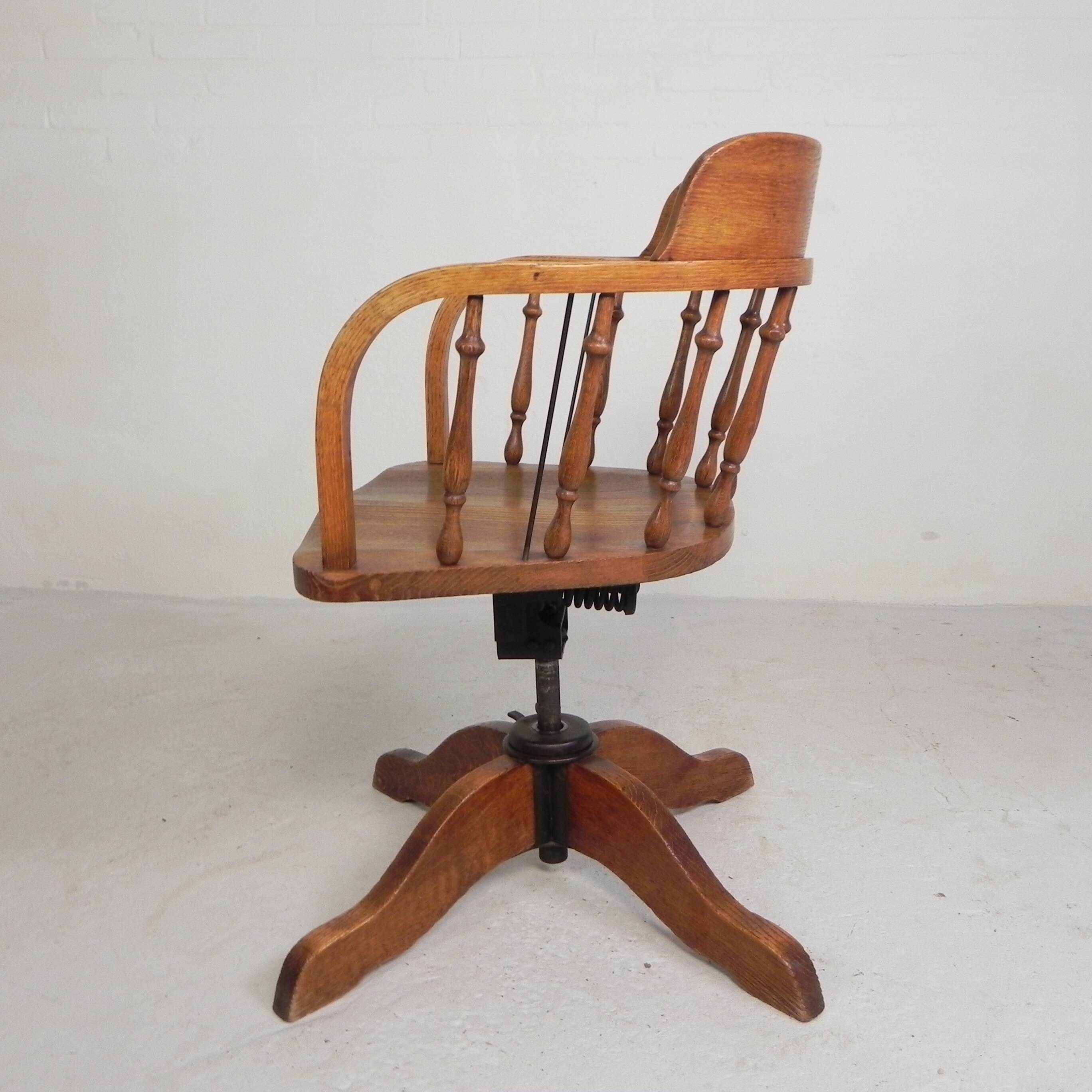 Oak office chair with a spring system and height adjustable, 1930s.