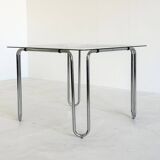 Italian vintage dining table with smooth glass and tubular frame base