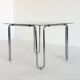 Italian vintage dining table with smooth glass and tubular frame base