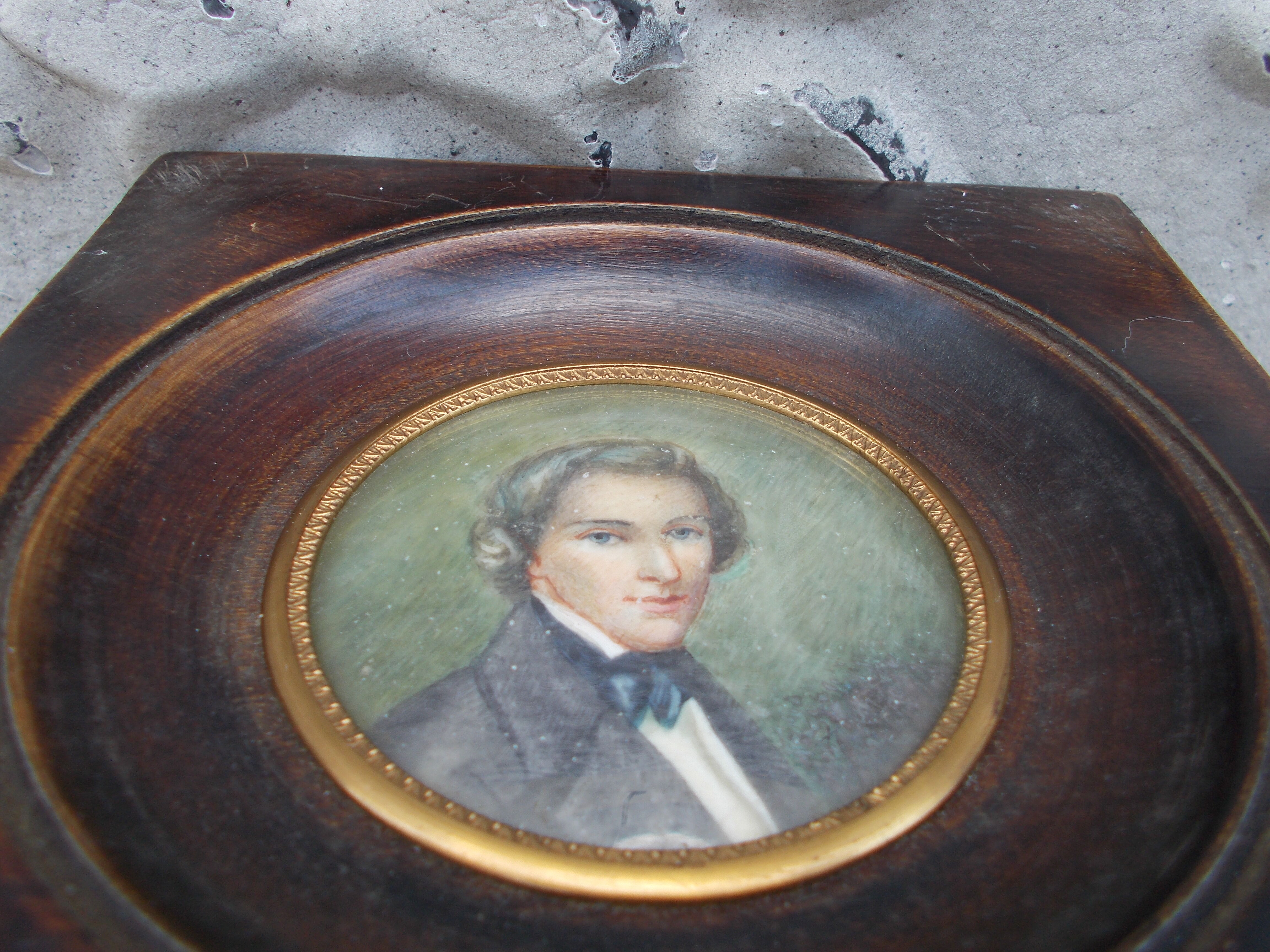 Miniature portrait of a man in a wooden frame