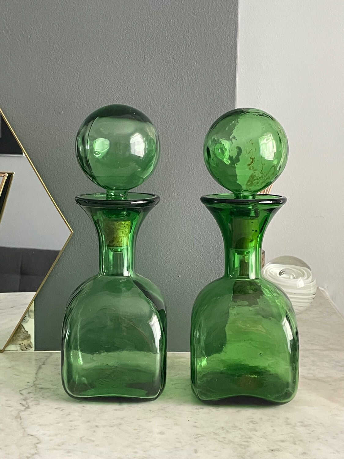 Two green glass decanters
