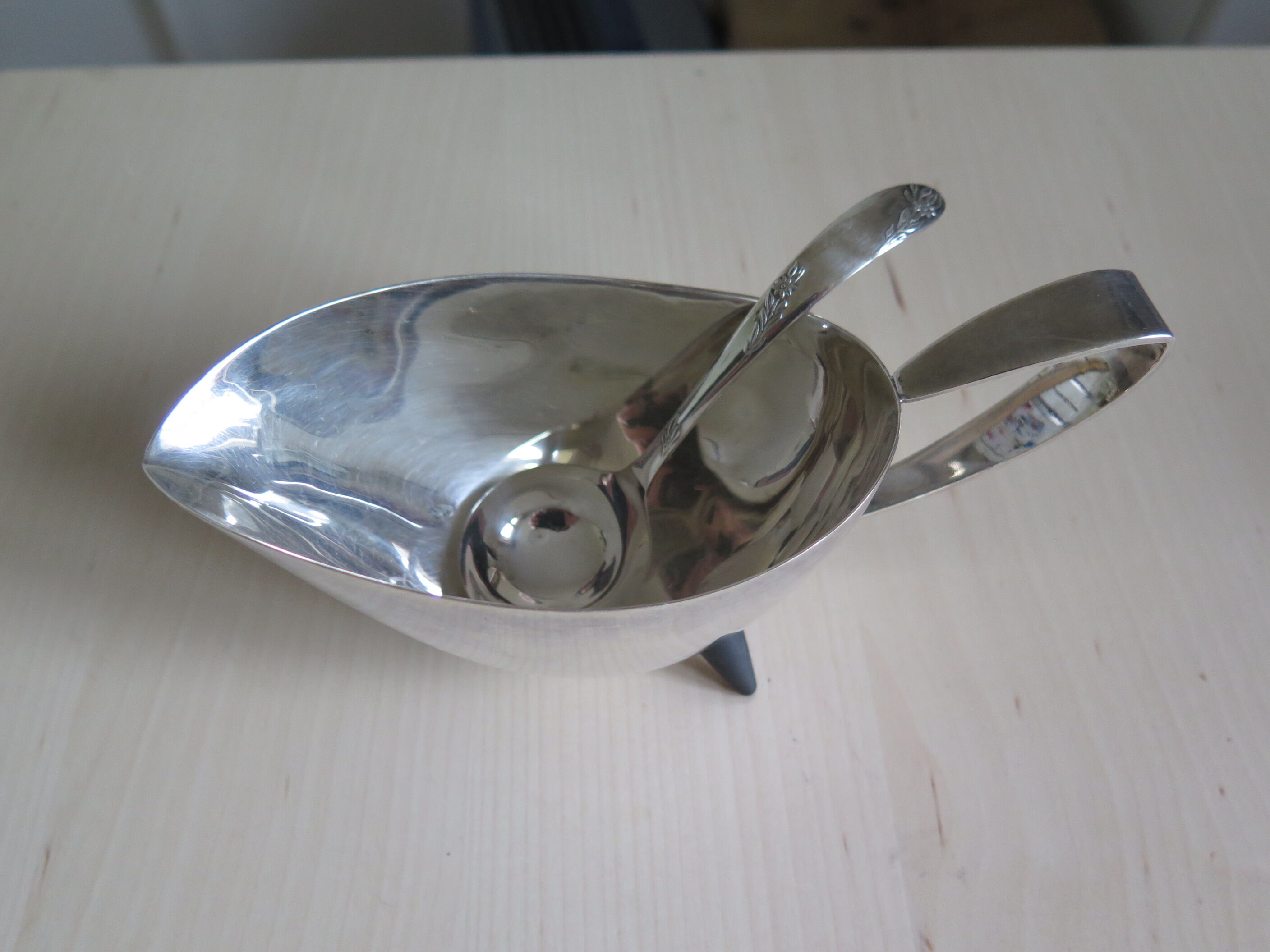 Angora tripod and silver metal spoon