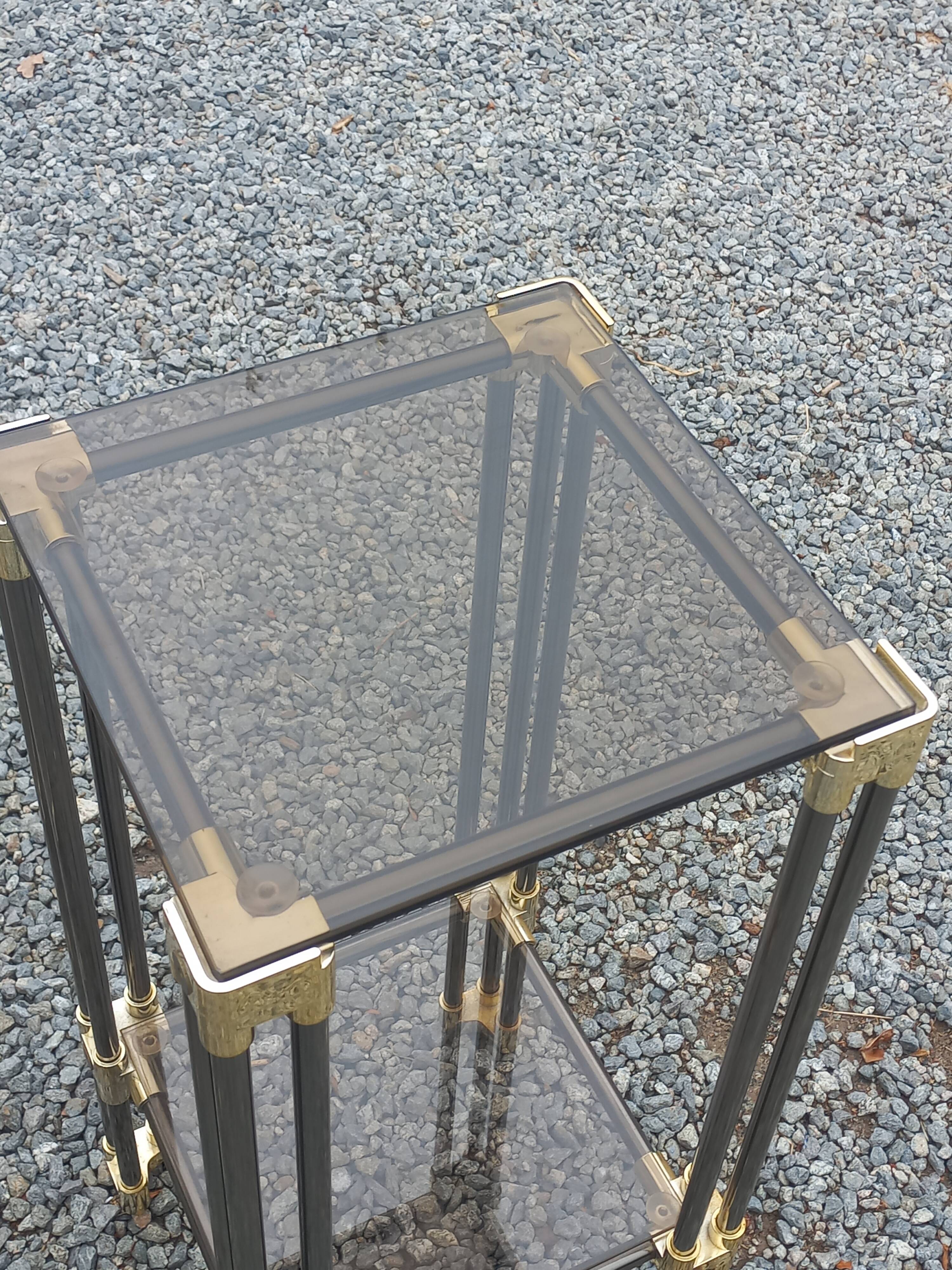 Pair of Hollywood Regency side tables in gold metal and smoked glass.