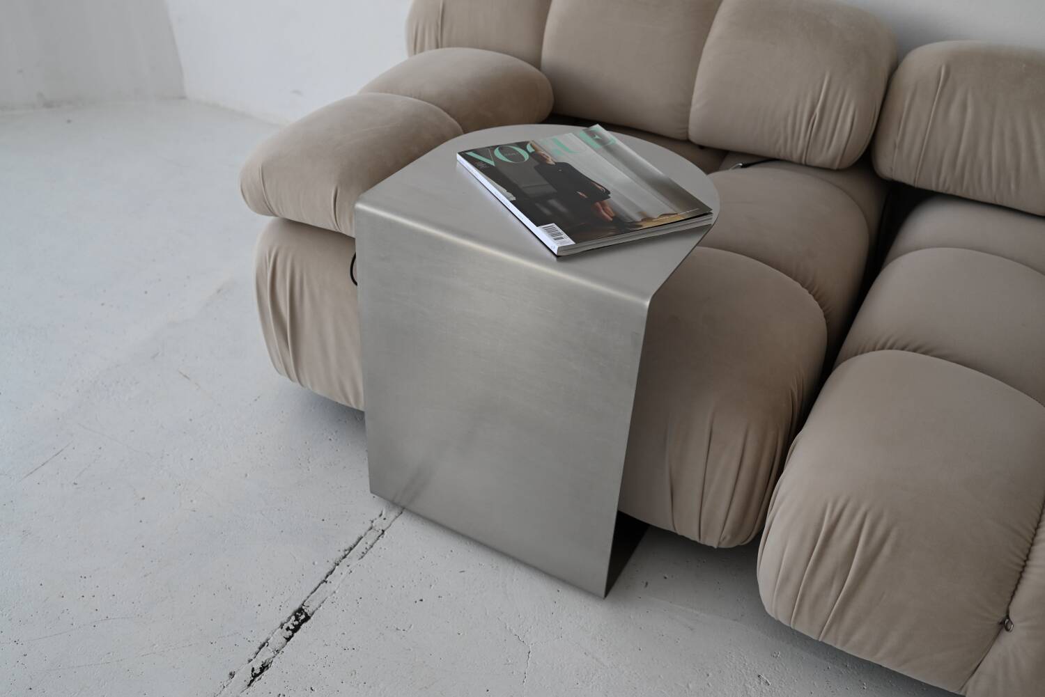 C-shaped brushed stainless steel side table