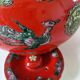 Vintage red Chinese teapot decorated with dragons and symbols.