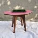 Small Scandinavian side table with wood and pink tiles, with tapered legs.