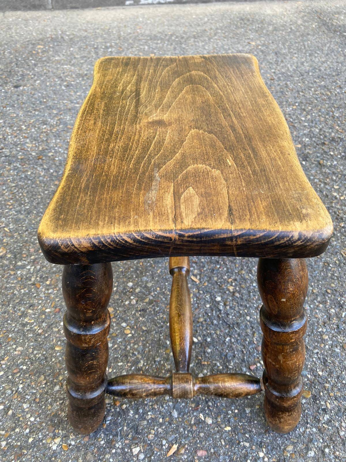 Small vintage low stool made of turned solid wood footrest 1960