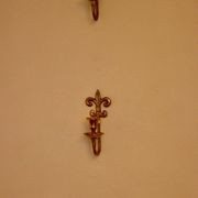 A pair of antique brass wall sconces.