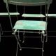 Set of 8 green painted metal industrial folding chairs.