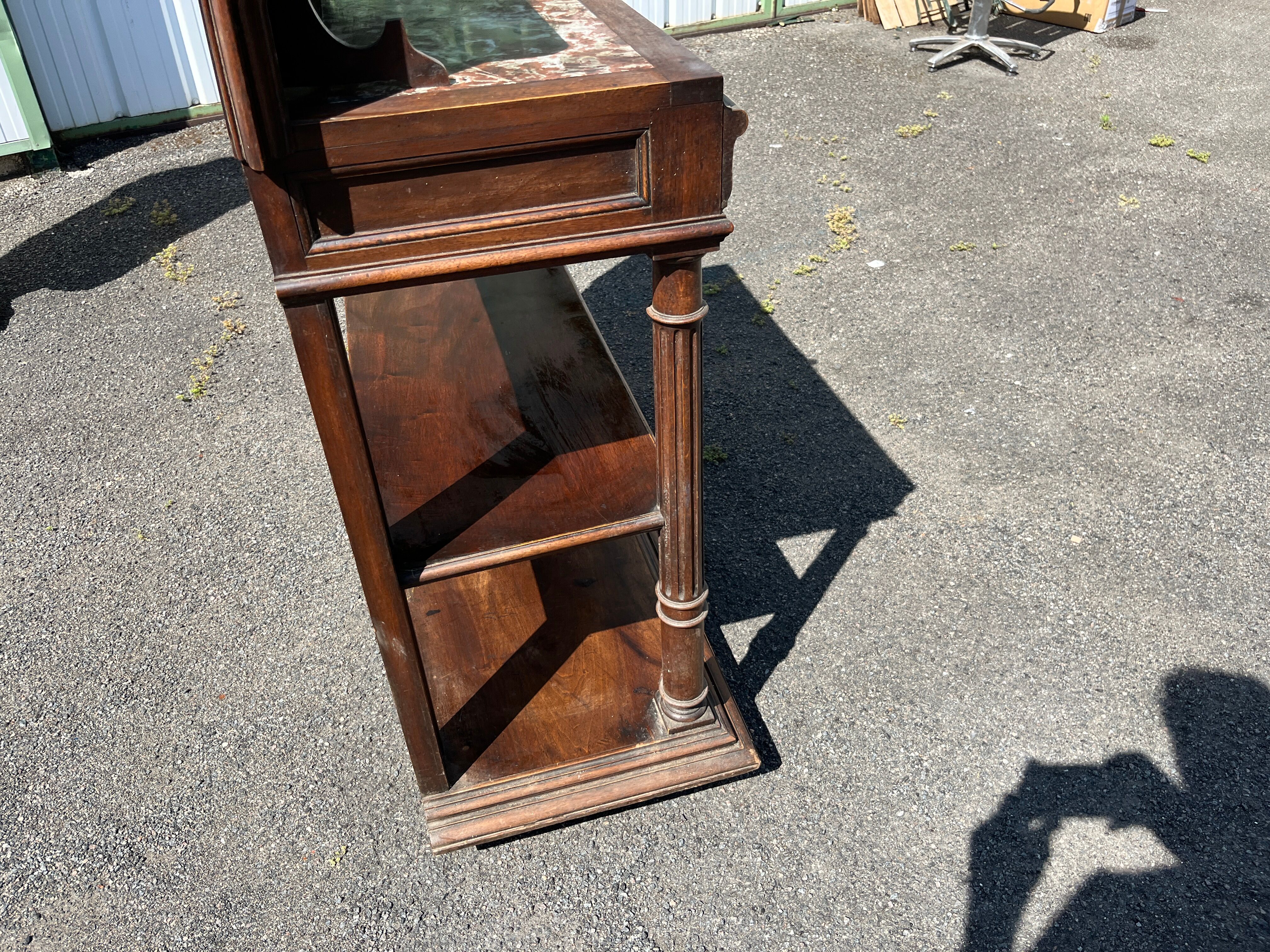 Carved wooden console table with three shelves and drop-leaf flap
